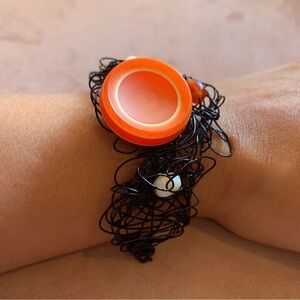 Handmade black twisted wire with orange button and white beads bracelet